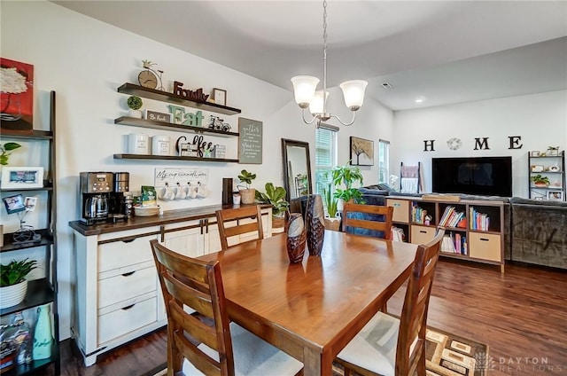 dining room featuring an inviting chandelier and dark wood-type flooring