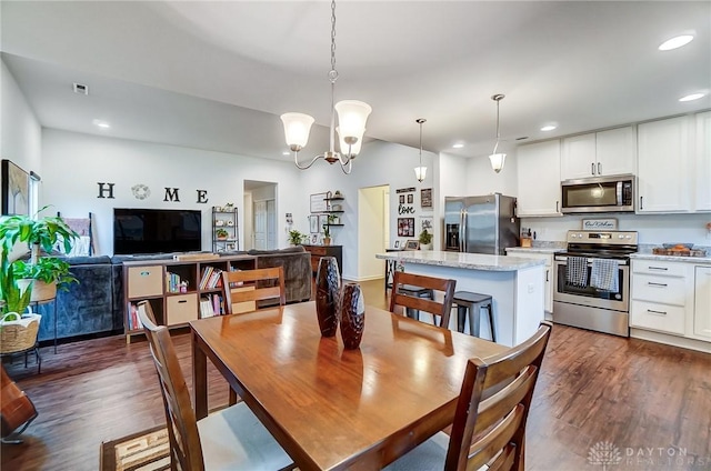 dining room with dark hardwood / wood-style flooring and a chandelier