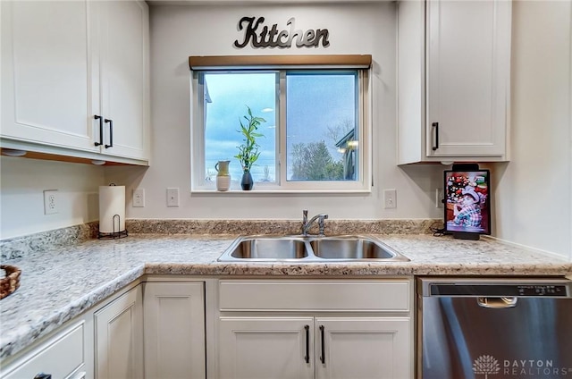 kitchen with white cabinetry, dishwasher, sink, and light stone counters