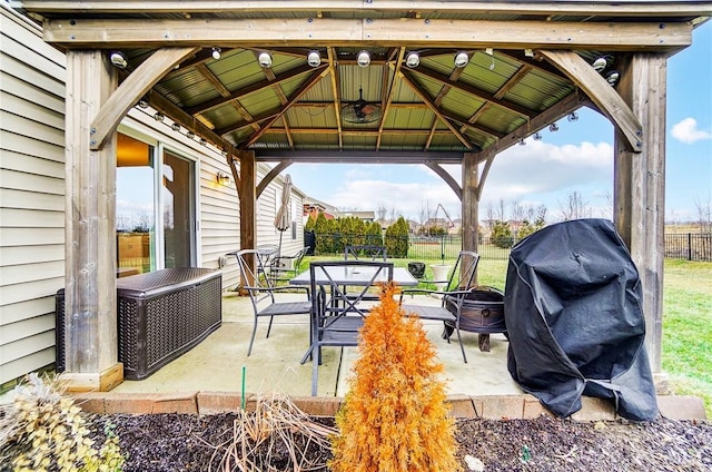 view of patio / terrace featuring a gazebo, area for grilling, and an outdoor fire pit