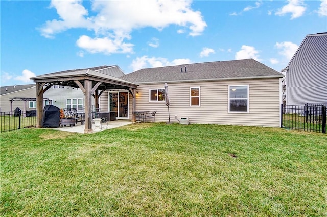 rear view of property featuring a gazebo, a yard, and a patio area