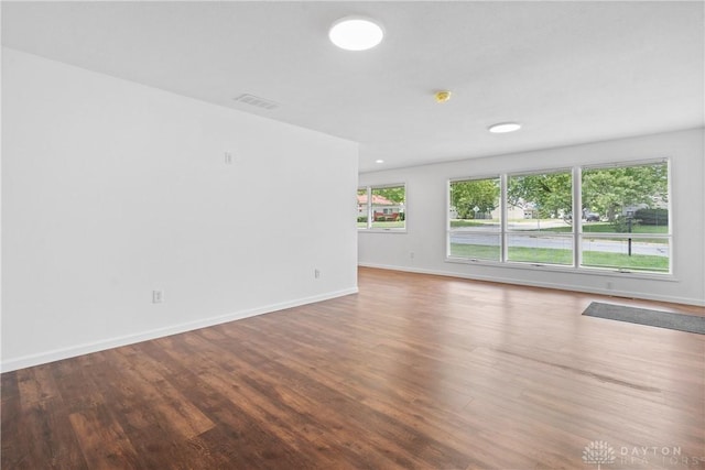 unfurnished room with hardwood / wood-style flooring