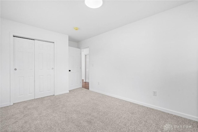 unfurnished bedroom featuring a closet and carpet flooring