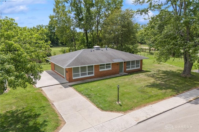 ranch-style house with a garage and a front yard