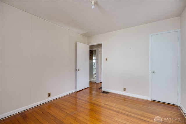 unfurnished room with light wood-type flooring