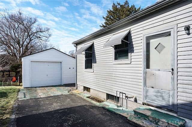 view of side of home with a garage and an outdoor structure