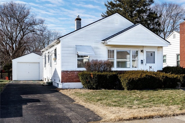 bungalow-style house with a garage and an outdoor structure