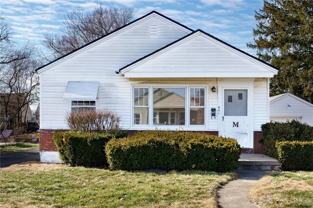 bungalow-style house with a front lawn