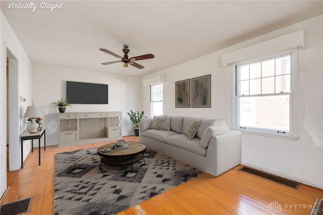 living room with hardwood / wood-style floors and ceiling fan