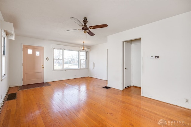 foyer entrance with ceiling fan with notable chandelier and light hardwood / wood-style flooring