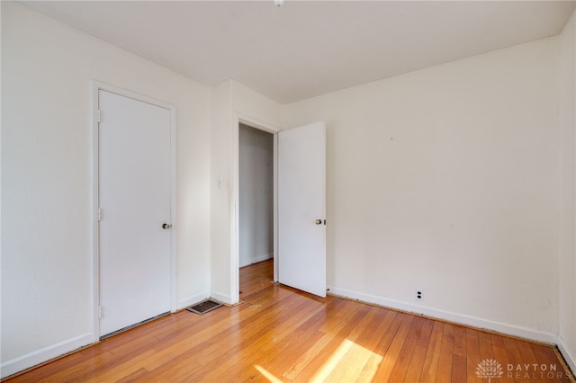 unfurnished bedroom with light wood-type flooring