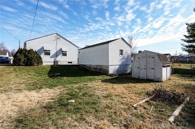 view of side of property featuring a shed and a lawn