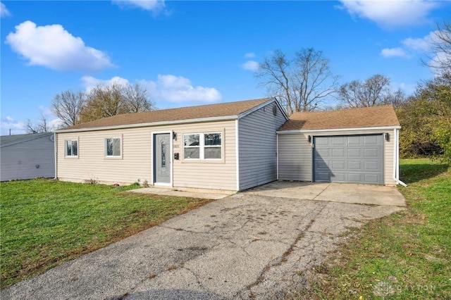 single story home featuring a garage and a front lawn