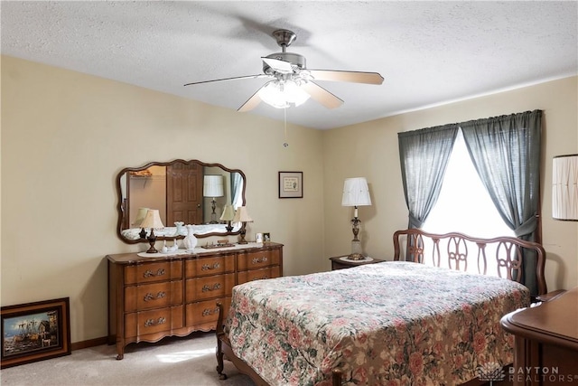 bedroom with multiple windows, light colored carpet, and a textured ceiling