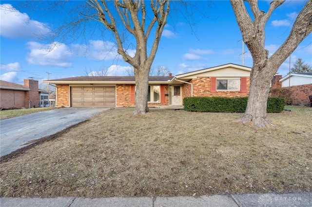 ranch-style home with a garage and a front yard