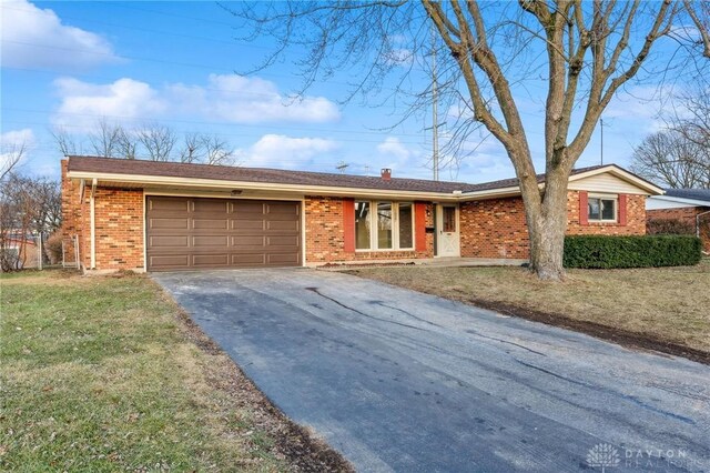 ranch-style home featuring a garage and a front yard