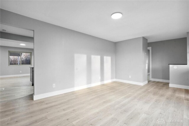 empty room with light hardwood / wood-style flooring