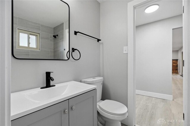 bathroom featuring vanity, toilet, and hardwood / wood-style floors