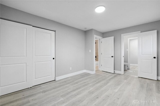 unfurnished bedroom with light hardwood / wood-style floors and a closet