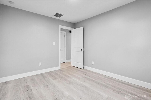 spare room featuring light hardwood / wood-style floors