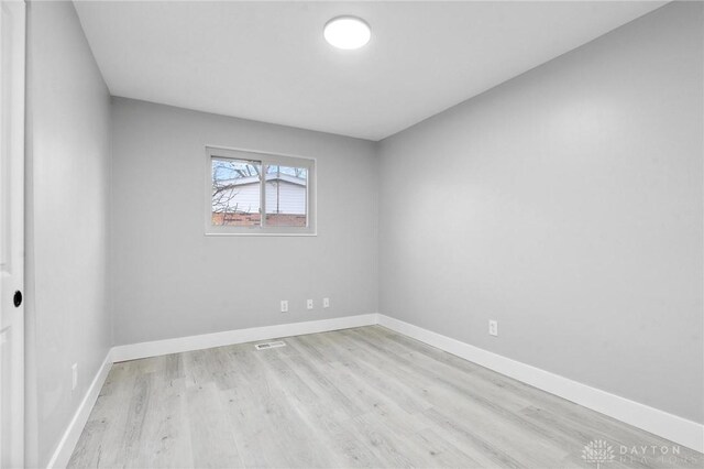 empty room with light hardwood / wood-style flooring