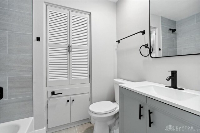 full bathroom with vanity, toilet, and tiled shower / bath combo