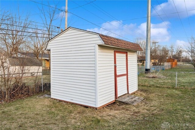 view of outbuilding with a yard