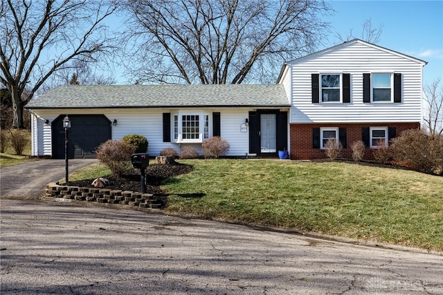 split level home featuring a garage and a front yard