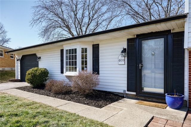 view of exterior entry featuring a garage