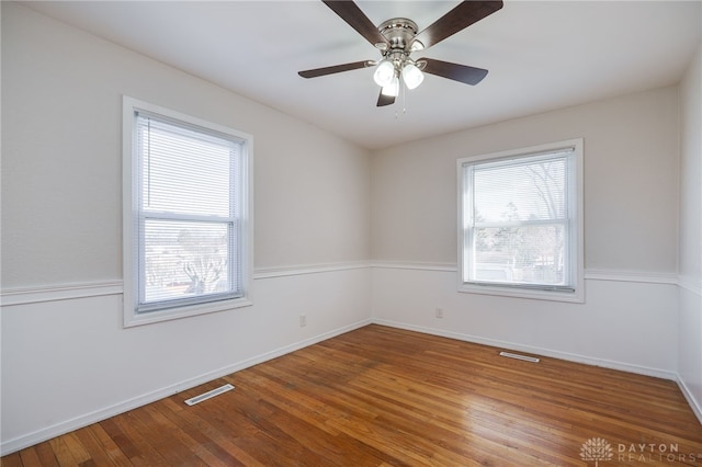 unfurnished room with hardwood / wood-style floors and ceiling fan