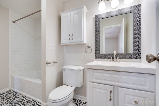 full bathroom featuring vanity, tiled shower / bath, and toilet