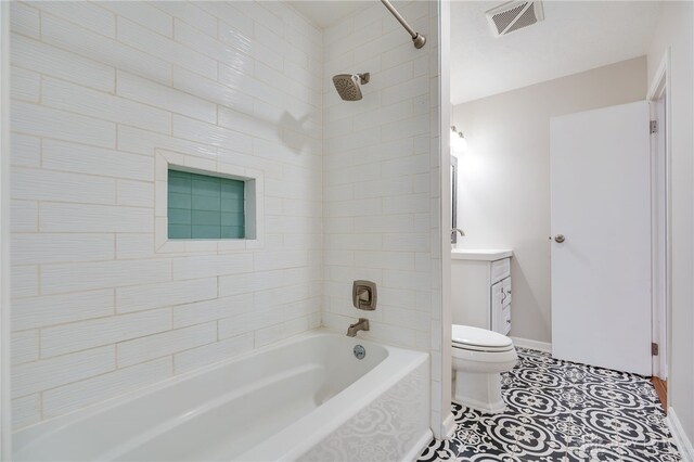 full bathroom featuring tile patterned flooring, vanity, toilet, and tiled shower / bath