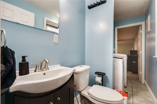 bathroom with vanity, toilet, and tile patterned flooring