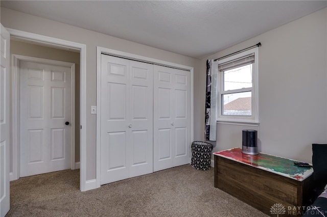 carpeted bedroom featuring a closet