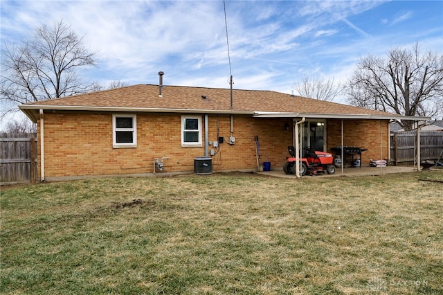 rear view of house featuring a yard, a patio area, and central air condition unit