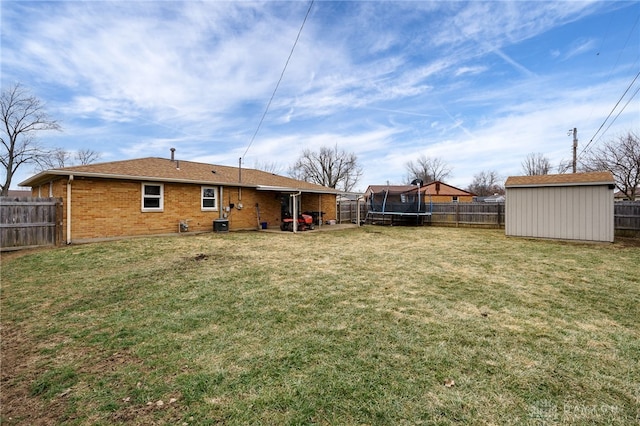 view of yard with a storage unit and a trampoline