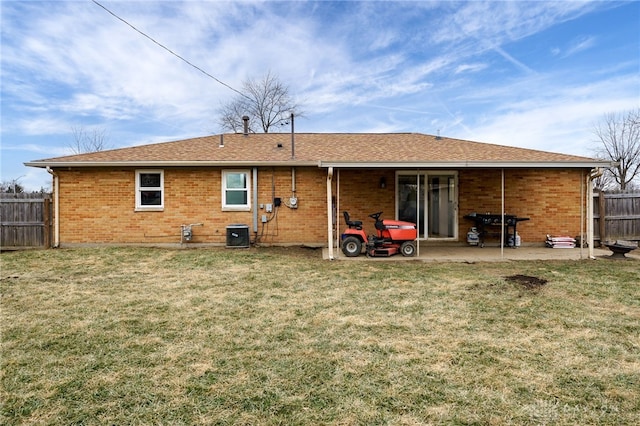 back of property featuring a yard, central AC unit, and a patio