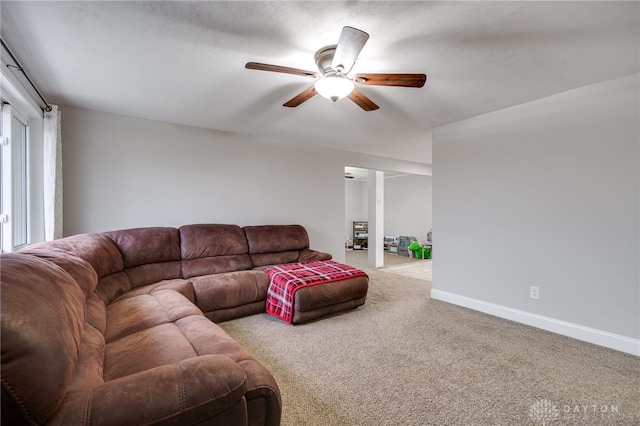 carpeted living room featuring ceiling fan