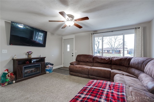 living room featuring ceiling fan and carpet