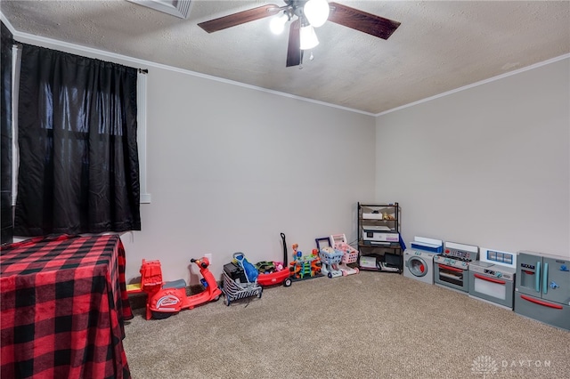 game room featuring ceiling fan, crown molding, a textured ceiling, and carpet