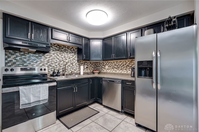 kitchen featuring tasteful backsplash, sink, stainless steel appliances, and light tile patterned flooring