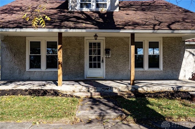 doorway to property featuring a porch