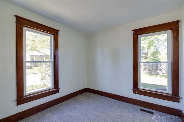 unfurnished room with plenty of natural light and carpet floors