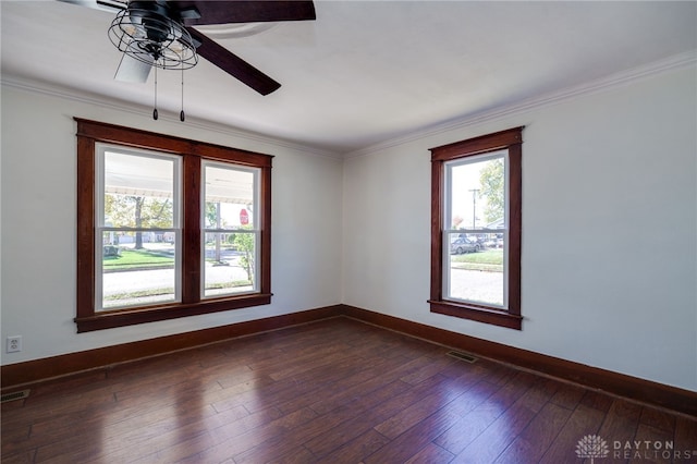 spare room featuring crown molding, dark wood-type flooring, and ceiling fan