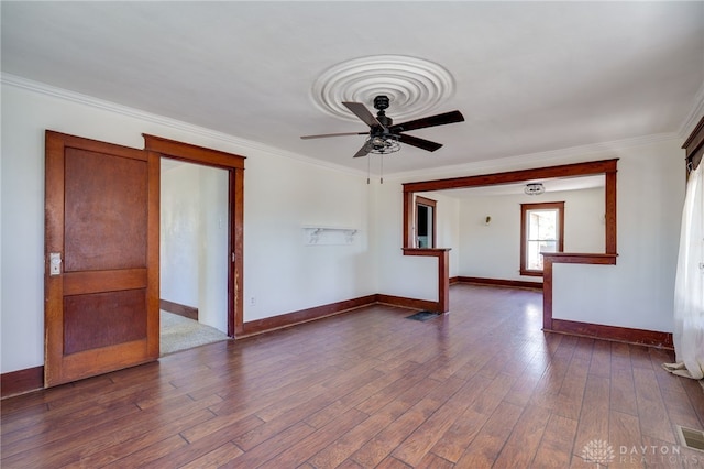 unfurnished living room with crown molding, dark hardwood / wood-style floors, and ceiling fan