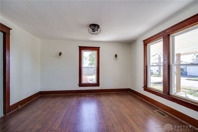 unfurnished room featuring dark hardwood / wood-style flooring