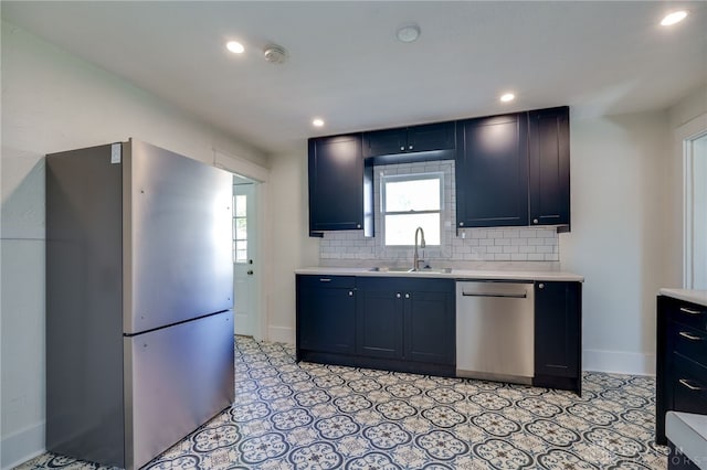 kitchen featuring stainless steel appliances, sink, and decorative backsplash