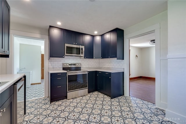 kitchen with backsplash and appliances with stainless steel finishes