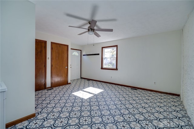 unfurnished bedroom featuring two closets and ceiling fan