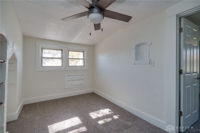 unfurnished room with ceiling fan, carpet flooring, and a textured ceiling